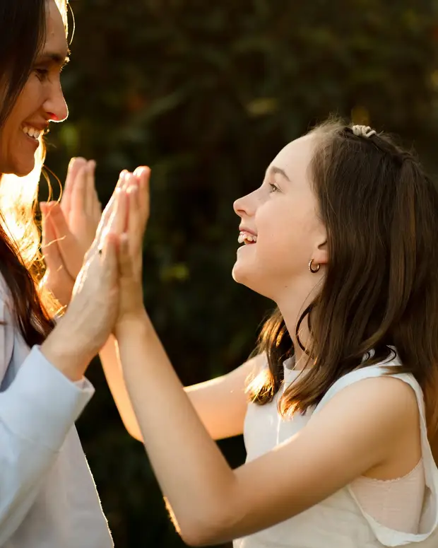 An adult and a child doing a hands-on activity together