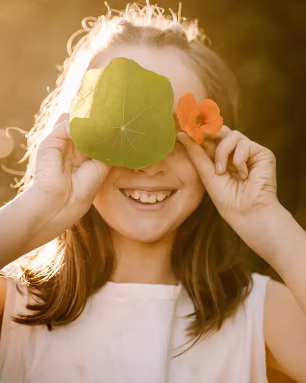 A child playing outdoors in golden afternoon light